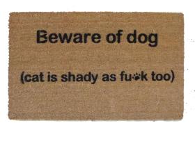 Coir doormat with "Beware of Dog, Cat is shady" text design