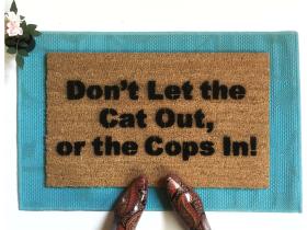 Funny doormat reading "Don't let the Cat out, or the Cops in!"