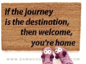 Natural coir doormat printed with 'If the journey is the destination, then welcome, you're home' in boho lettering