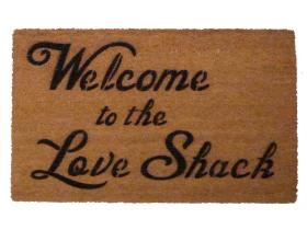 Coir doormat with groovy retro text reading "Welcome to the Love Shack" from the B-52's song