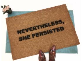Sustainable coir doormat printed with Nevertheless, She Persisted feminist welcome mat design