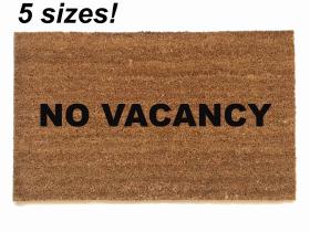 Sustainable coir doormat printed with NO VACANCY in bold black text, a funny rude welcome mat for the front door.