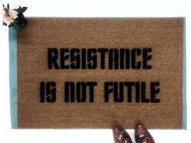 Brown coir doormat with 'Resistance Is NOT Futile' sci-fi welcome mat design