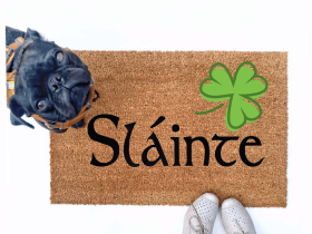 Failte shamrock St Patrick's day coir doormat with a little black pug