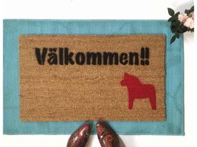 Sustainable coir doormat with italic Välkommen script, Swedish welcome mat for front door