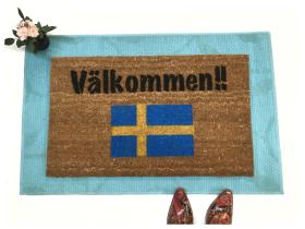 Coir doormat with Swedish flag and Välkommen welcome text at a front door