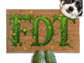 A dog standing on a coir doormat with the word "FDT" written on it in green vines, with a person's feet visible underneath.