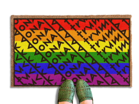 a pair of feet in green shoes standing on a colorful gay pride rainbow flag, patterned doormat with a geometric Fuck Donald Trump design .