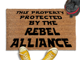 This Property Protected by the Rebel Alliance Nerdy Doormat with black pug in a red collar looking up at someone in yellow fish head converse sneakers