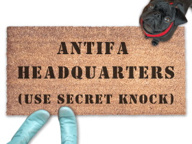 ANTIFA HEADQUARTERS doormat pictured with a little black pug looking up at someone in Smurf blue boots