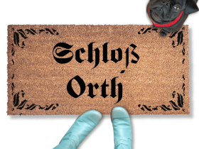 Custom Personalized name doormat with a fancy leaves border and a black pug looking up at someone oin blue boots