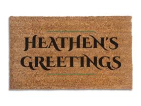 Coir doormat printed with Heathen's Greetings in black engraved capitals between thin green rules