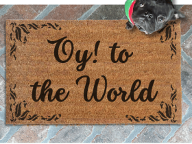 Coir doormat printed with Oy to the world, wipe your feet in bold blue letters