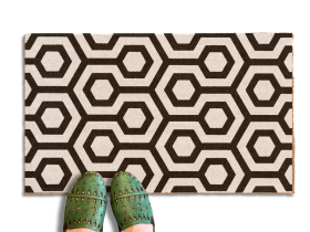 The shining hex carpet pattern printed in black and white on a coir doormat